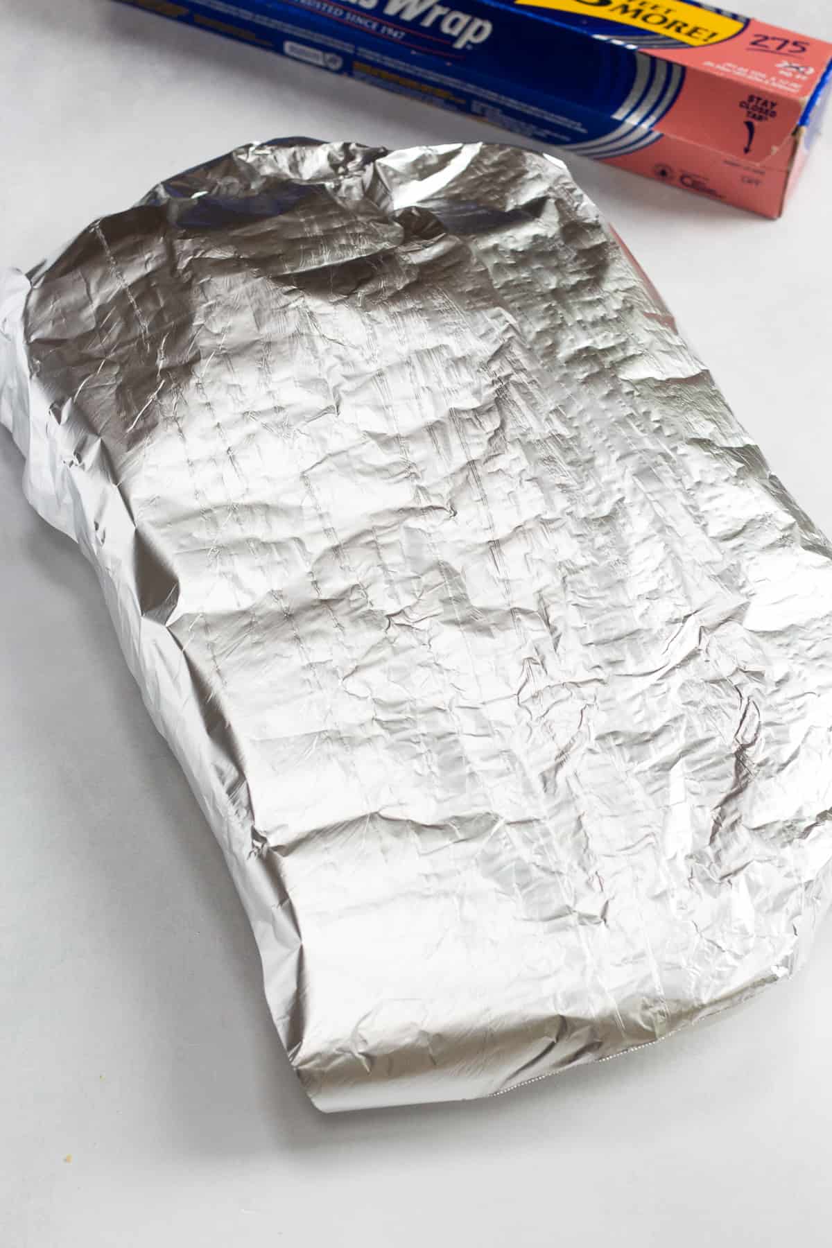 A baking dish covered by aluminum foil.