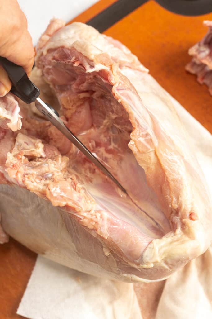 Scoring the inside of a turkey breast.