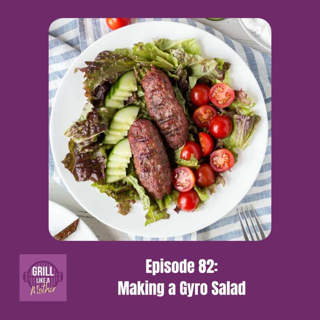 promo image for Grill Like A Mother podcast episode 82: Making a Gyro Salad. An overhead shot of a white bowl with lettuce, chopped cucumber, halved cherry tomatoes, and two grilled ground lamb kabobs is shown on a dark purple background with white text at the bottom showing the episode name and number.