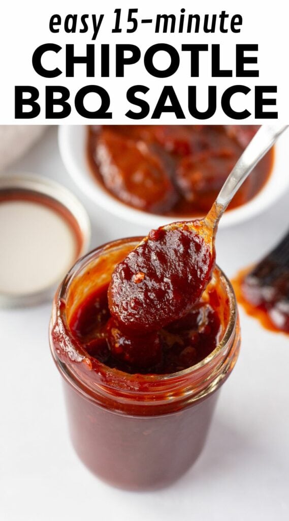 Pinterest image with black text on a white background at the top that reads "easy 15-minute chipotle bbq sauce" and an image showing a spoon dipping into a mason jar with bbq sauce in it surrounded by a lid, a bbq brush, a plate of chipotle peppers, and a tan cloth napkin.
