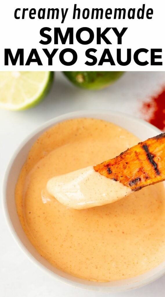 pinterest image with a large picture of a sweet ptoato fry being dipped in an orange sauce in a bowl in the bottom ¾ of the image, and the top part showing a white background with black text that reads "creamy homemade smoky mayo sauce".