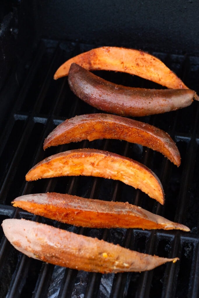 Sweet potato wedges on a hot grill.